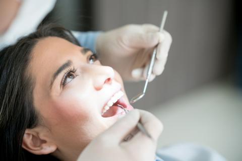 un médecin avec du matériel dentaire en consultation avec une patiente 